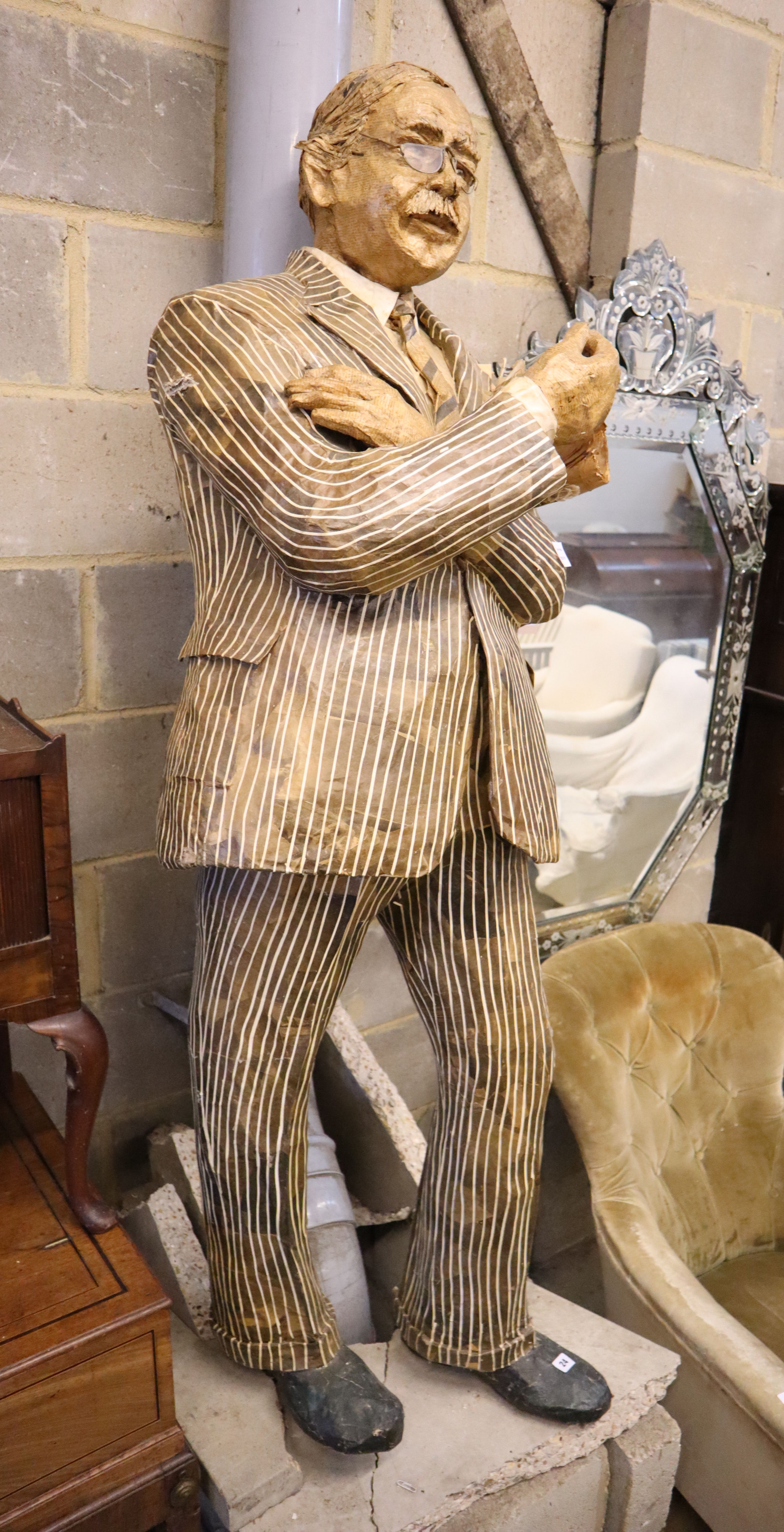 A stuffed papier mache figure of a gentleman holding the Sunday Times, height 170cm